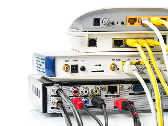 Three electronic devices with ethernet and coaxial cables attached
