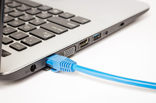 Ethernet cable attached to laptop computer