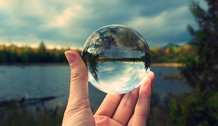 Hand holding a glass sphere