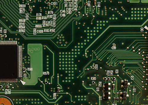 printed circuit board with lots of small green circles on its surface