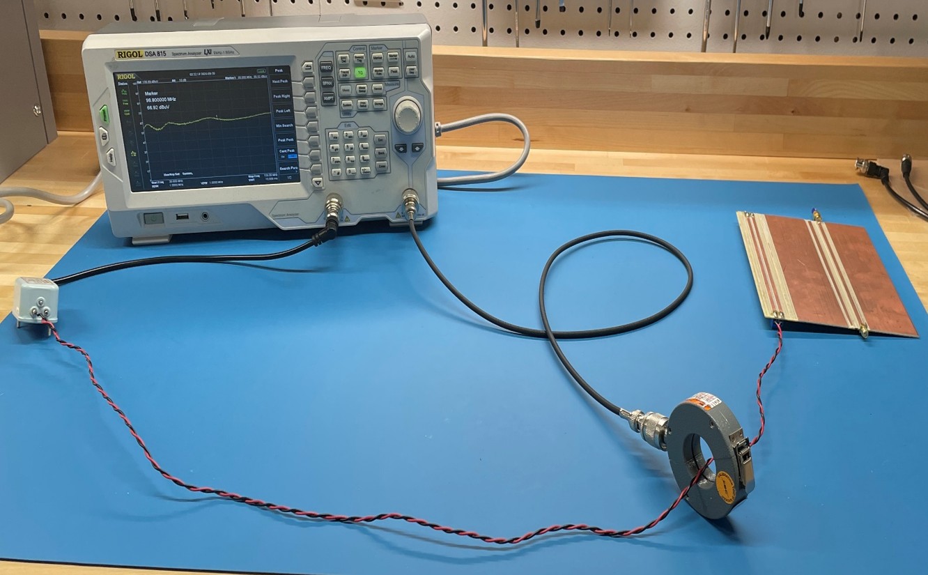 spectrum analyzer with tracking generator driving a balun connected to a twisted wire pair connected to a differential trace pair