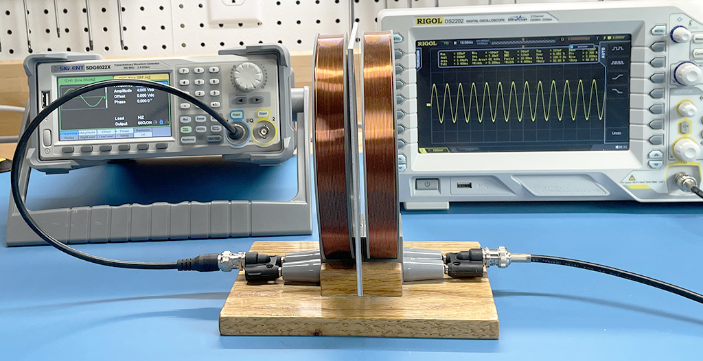 signal generator connected to coil 1 and oscilloscope connected to coil 2 with an aluminum plate between the coils