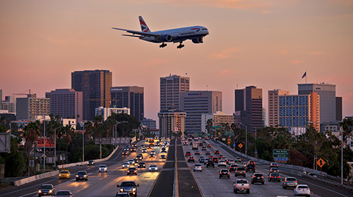 plane flying low over traffic